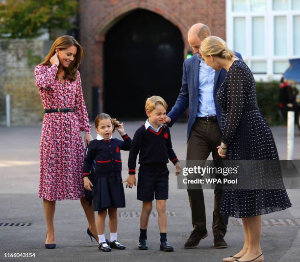 Helen Haslem , head of the lower school greets Princess Charlotte as she arrives for her first day of school, with her brother Prince George and her...