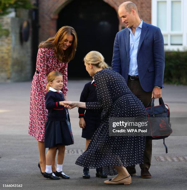 Helen Haslem, head of the lower school greets Princess Charlotte as she arrives for her first day of school, with her brother Prince George and her...