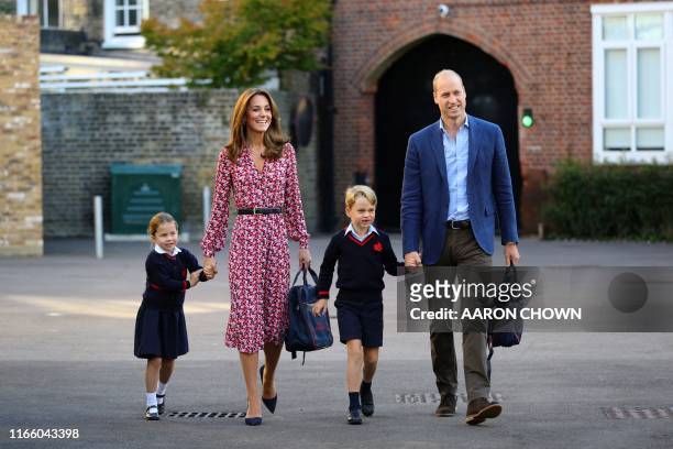 Britain's Princess Charlotte of Cambridge, accompanied by her father, Britain's Prince William, Duke of Cambridge, her mother, Britain's Catherine,...