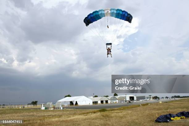 skydiving tandem couple jump with friends - landing touching down stock pictures, royalty-free photos & images