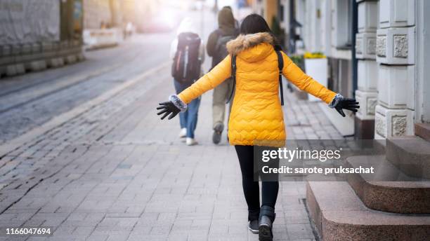 the backside of asian female tourist traveling road trip in helsinki , finland on holiday, city travel . for travel concept. - helsinki stock pictures, royalty-free photos & images