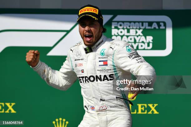 Race winner Lewis Hamilton of Great Britain and Mercedes GP celebrates on the podium during the F1 Grand Prix of Hungary at Hungaroring on August 04,...