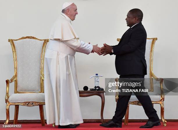 Pope Francis shakes hands after Mozambique President Filipe Nyusi speech during a meeting with the authorities, the civil society and the diplomatic...