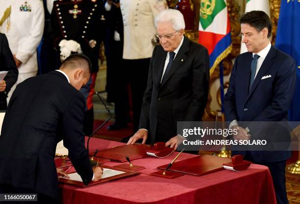 Italy's Foreign Minister Luigi Di Maio signs an oath of office before Italy's President Sergio Mattarella and Italy's Prime Minister Giuseppe Conte...