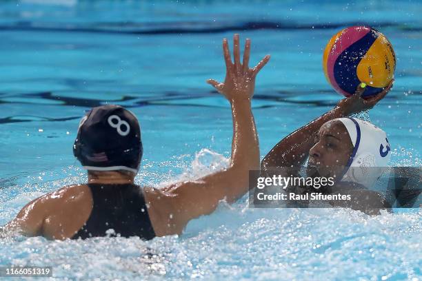 Osmarie Quiñones of Puerto Rico and Kiley Neushul of United States fight for the ball during Women's Waterpolo Preliminary Group A match between...