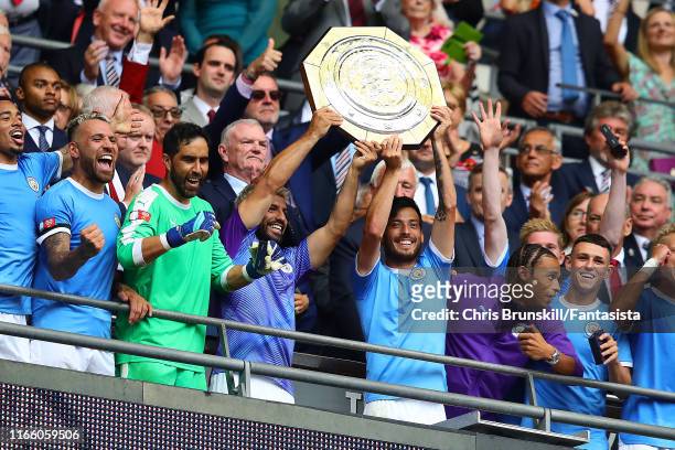 Sergio Aguero and David Silva of Manchester City lift the trophy following the FA Community Shield match between Liverpool and Manchester City at...