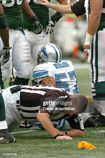 Umpire Bill Schuster receives a bloody nose after being trapped in a pile up during a game between the Detroit Lions and New York Jets on October 22,...