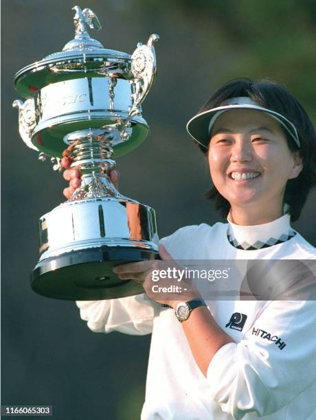 Japanese female golfer Hiromi Kobayashi holds up the US LPGA Japan Classic winner's trophy during the award ceremony at Musashigaoka Golf Club...