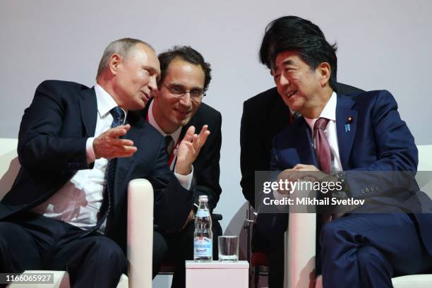 Russian President Vladimir Putin talks to Japanese Prime Minister Shinzo Abe while visiting the Annual International Vladivostok Jigoro Junior Judo...