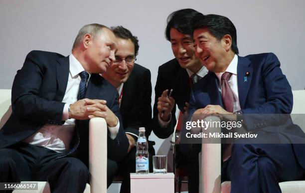 Russian President Vladimir Putin talks to Japanese Prime Minister Shinzo Abe while visiting the Annual International Vladivostok Jigoro Junior Judo...