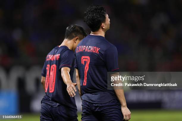 Chanathip Songkrasin of Thailand hugs Supachok Sarachart of Thailand during the FIFA World Cup Asian second qualifier match between Thailand and...