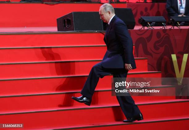 Russian President Vladimir Putin goes up the stairs while visiting the Annual International Vladivostok Jigoro Junior Judo Tournament after the...