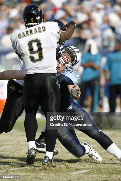 Kyle Vanden Bosch of the Titans has his helmet come off while making a hit on David Garrard during 1st-half action between the Jacksonville Jaguars...
