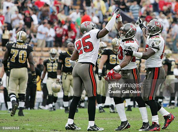 The Tampa Bay Buccaneers Ronde Barber, center, is congratulated by his steammates after Barber intercepted a pass thrown by New Orleans Saints...