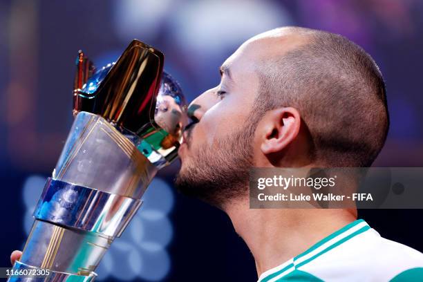 Mo Harkous of Germany kisses the trophy following victory in the FIFA eWorld Cup Final against Mosaad Aldossary of Saudi Arabia during Finals day of...