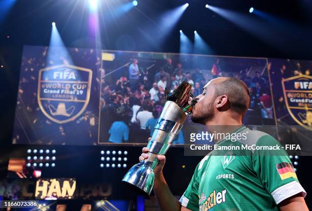 Mo Harkous of Germany kisses the trophy following victory in the FIFA eWorld Cup Final against Mosaad Aldossary of Saudi Arabia during Finals day of...