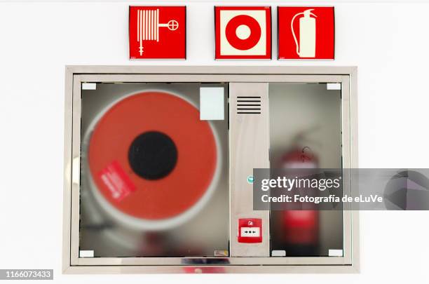 fire hose on wall - feuerwehrschlauch stock-fotos und bilder