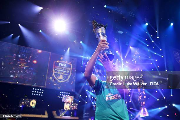 Mo Harkous of Germany lifts the trophy following victory in the FIFA eWorld Cup Final against Mosaad Aldossary of Saudi Arabia during Finals day of...