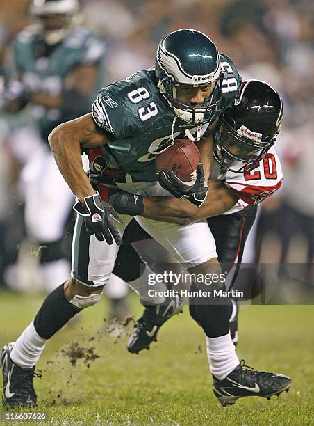 Eagles wide receiver Greg Lewis is tackled by Falcons cornerback Allen Rossum after catching a pass during the game between the Atlanta Falcons and...