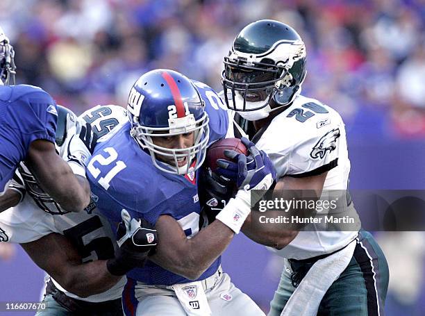 New York Giants' Tiki Barber is tackled by Brian Dawkins during Philadelphia Eagles vs New York Giants, The Meadowlands, East Rutherford, New Jersey,...