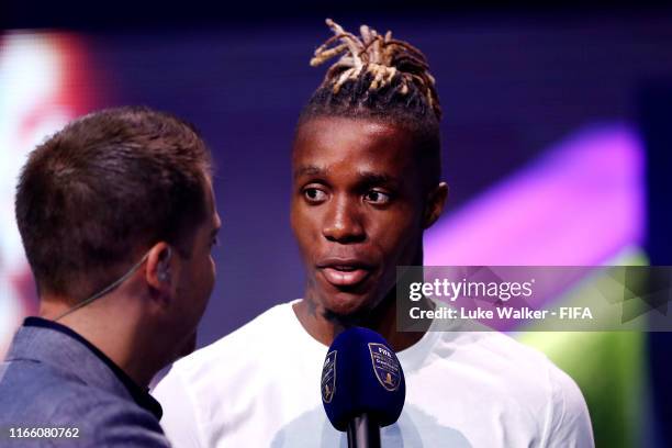 Wilfred Zaha is interviewed by Adam Smith following the FIFA eWorld Cup Final between Mo Harkous of Germany and Mosaad Aldossary of Saudi Arabia...
