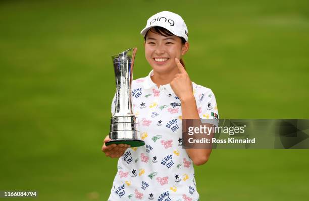 Hinako Shibuno of Japan celebrates with the trophy after the final round of the AIG Women's British Open at Woburn Golf Club on August 04, 2019 in...