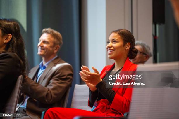 businesswoman applauding during seminar - reds training session stock pictures, royalty-free photos & images