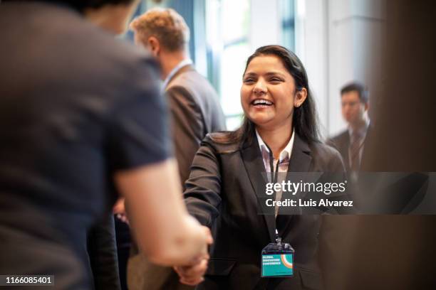 business women doing handshake in meeting - launch celebration ストックフォトと画像