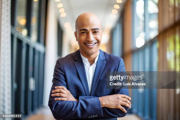 successful bald businessman in hotel corridor - chief executive officer stock-fotos und bilder