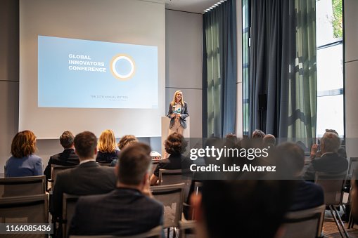 Businesswoman explaining new ideas and strategy in seminar Businesswoman explaining new ideas and strategy in seminar