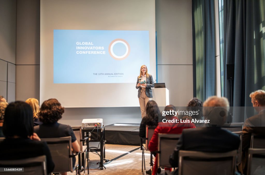 Female speaker addressing a seminar