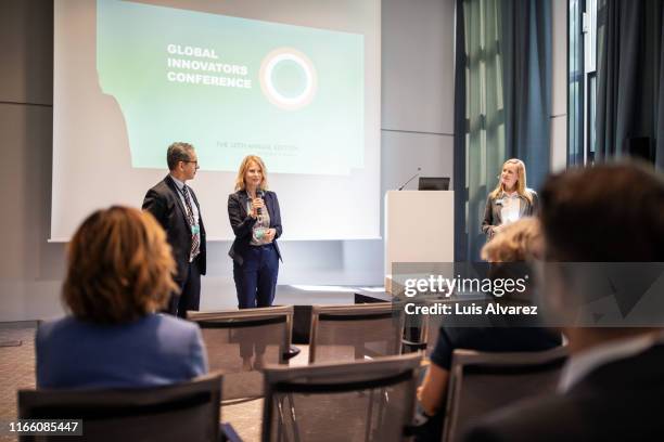 businesswoman giving speech at launch event - global launch of audi city digital showroom in london stockfoto's en -beelden