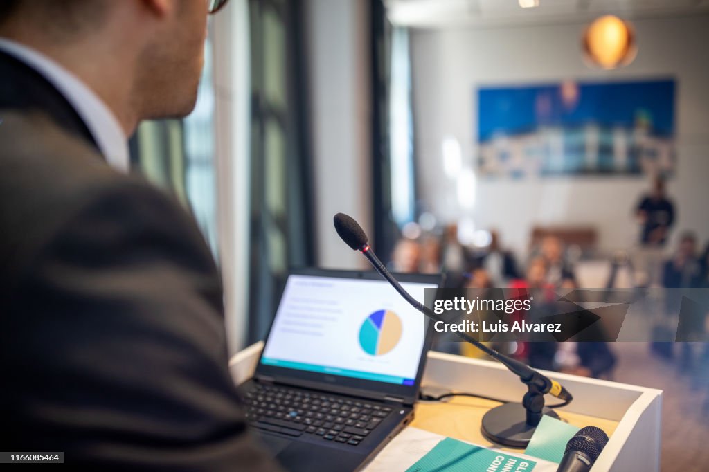 Businessman giving presentation at convention center