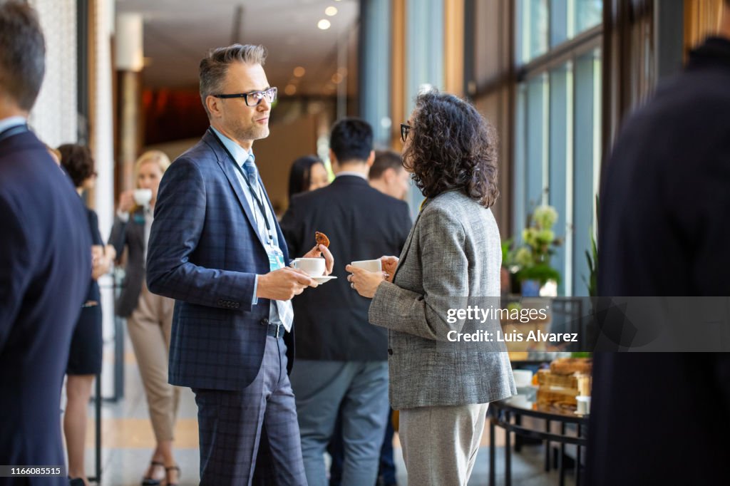 Business professionals during a coffee break in auditorium