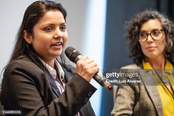 businesswoman sharing her views during a group discussion - panel discussion stock pictures, royalty-free photos & images