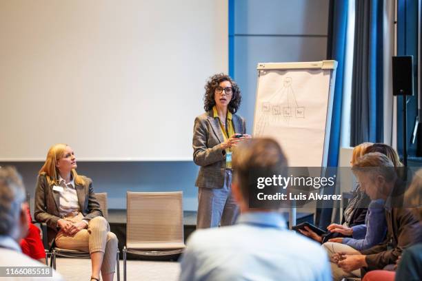 business professionals planning strategy during meeting - women podium stock-fotos und bilder