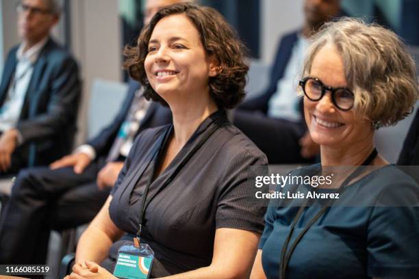 smiling mature businesswoman attending seminar - germany training press conference stock pictures, royalty-free photos & images