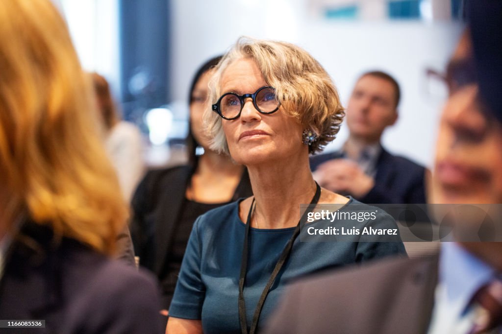 Senior businesswoman attending seminar