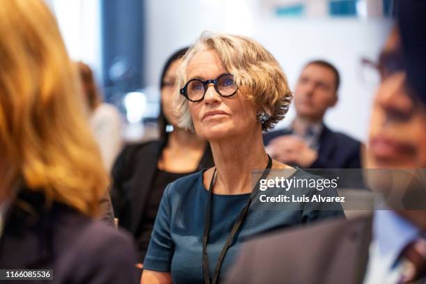 senior businesswoman attending seminar - event audience stock pictures, royalty-free photos & images
