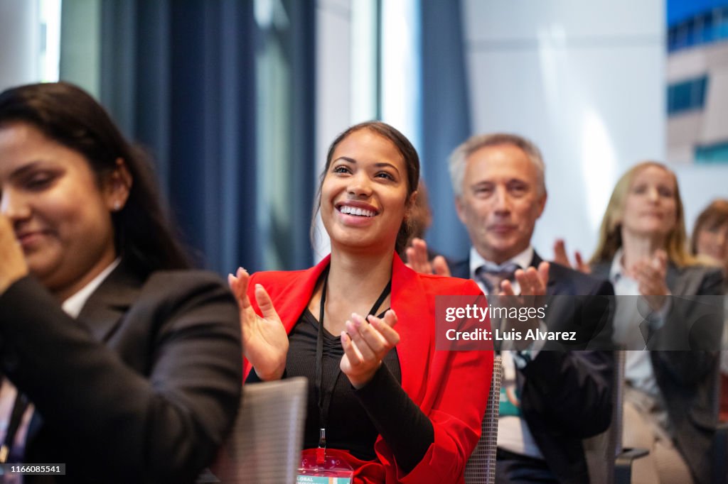 Business people applauding during launch event