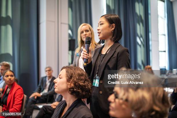 executive speaking during q and a session at seminar - faq stock pictures, royalty-free photos & images