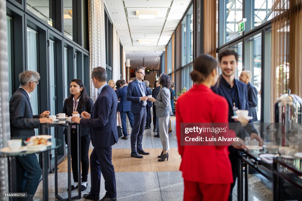 Business people having a refreshment break at conference