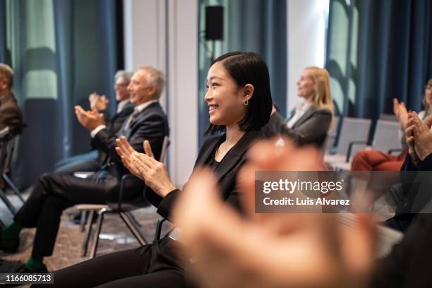 business professionals applauding in seminar - セミナー　日本人 ストックフォトと画像