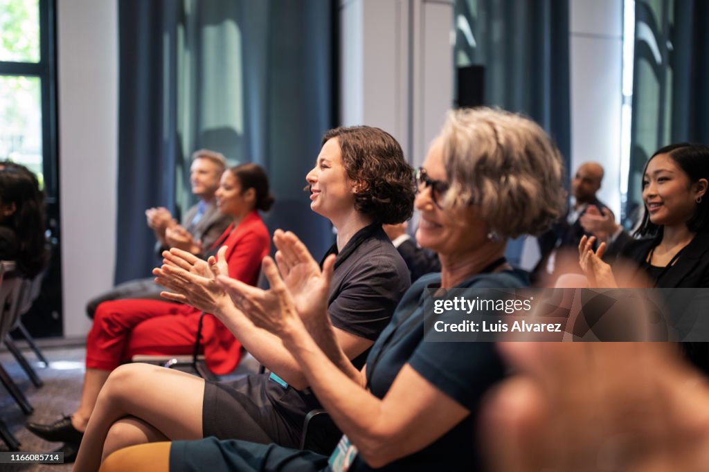 Executives applauding during conference