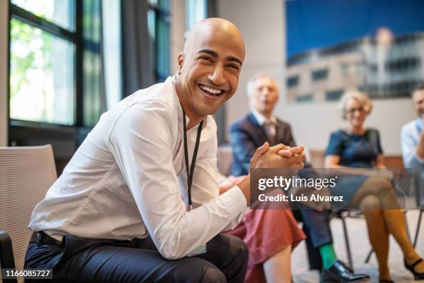 cheerful businessman at networking seminar - portrait business partners stock-fotos und bilder