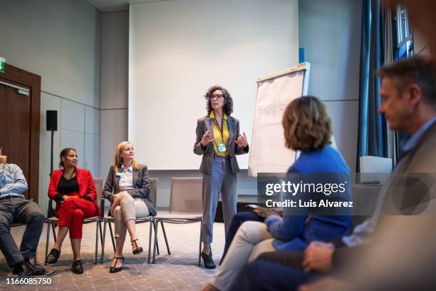 businesswoman giving presentation during a seminar - job candidate stock pictures, royalty-free photos & images