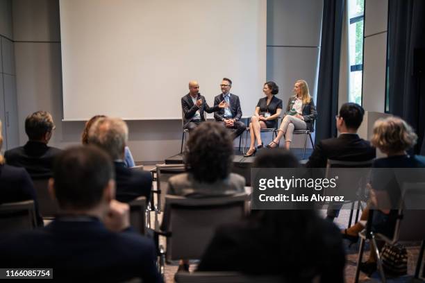 professionals in convention center during seminar - panelist stock pictures, royalty-free photos & images