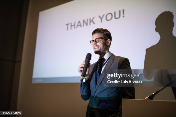 male professional giving presentation at convention center - conference center stockfoto's en -beelden