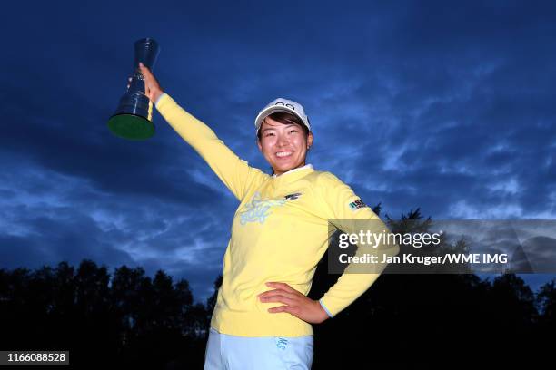 Hinako Shibuno of Japan poses for a photo with the AIG Women's British Open Trophy as she celebrates winning the tournament after Day Four of the AIG...