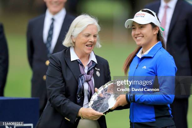 Atthaya Thutikul of Thailand the leading amateur is presented with her trophy by Gillian Kirkwood after the final round of the AIG Women's British...